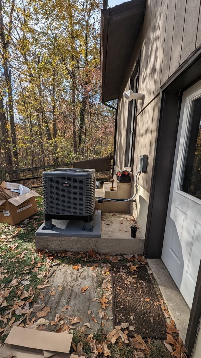 Central air conditioning condenser installed outside a home