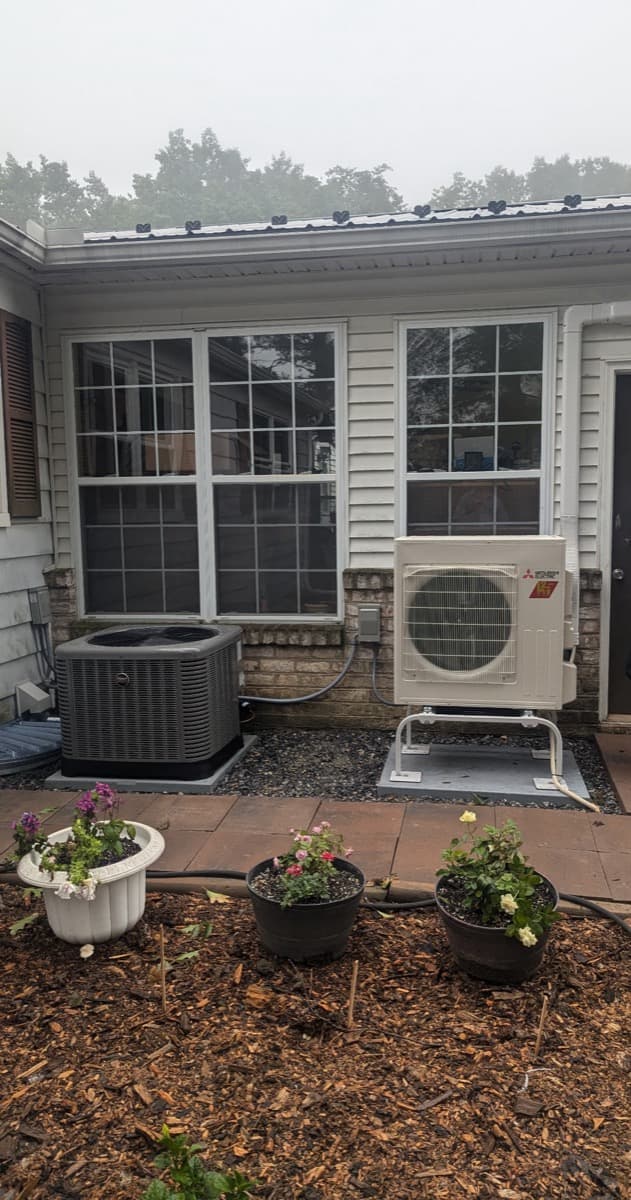 Central AC condenser and ductless mini-split outdoor unit installed side by side