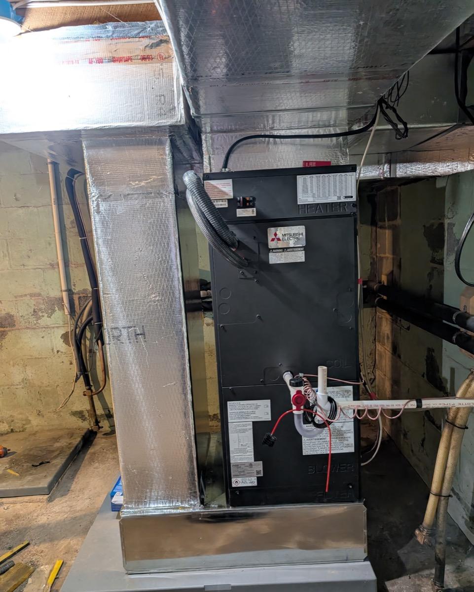 Ductless mini-split indoor air handler unit installed in a mechanical room